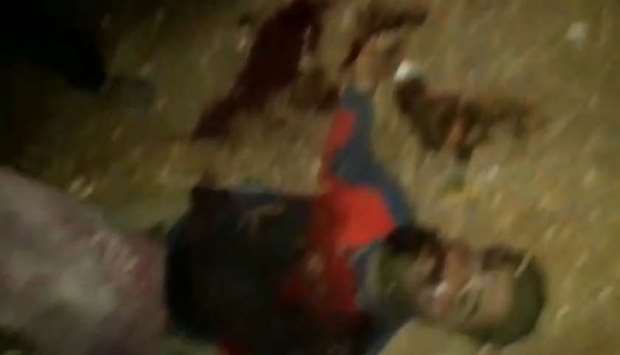 An image grab from a video circulating among local monitoring groups allegedly shows the body of a man who was fatally wounded in helicopter gunfire which was said to kill nine people near the northwestern Syrian village of Barisha in the Idlib province along the border with Turkey, where ,groups linked to the Islamic State group, were present, according to a Britain-based war monitor with sources inside Syria.
