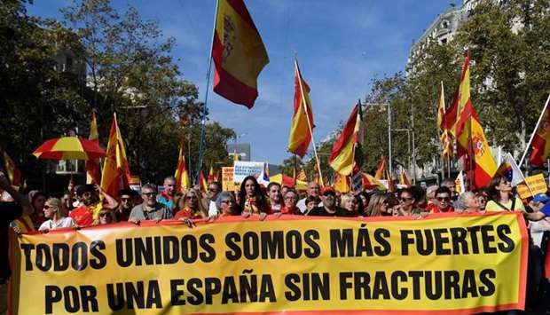 Demonstrators hold placards reading ,together we are stronger,, ,a few people can not speak for everyone, during a demonstration called by the anti-separatists organisation ,Societat Civil Catalana, (Catalan Civil Society, SCC), in Barcelona