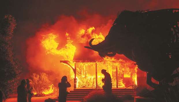 A building burns in the Kincade fire as flames raced yesterday through Healdsburg, California.