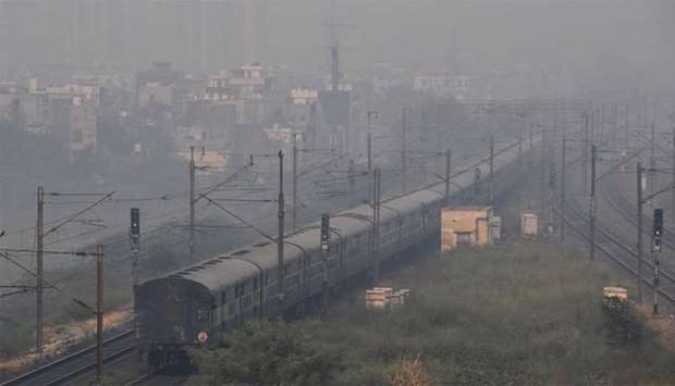 A train travels through heavy smog conditions in Ghaziabad on the outskirts of New Delhi