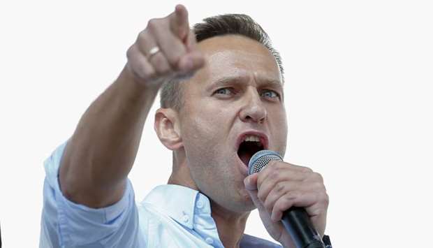 In this file photo taken on July 20, 2019 Russian opposition leader Alexei Navalny addresses demonstrators during a rally to support opposition and independent candidates after authorities refused to register them for September elections to the Moscow City Duma