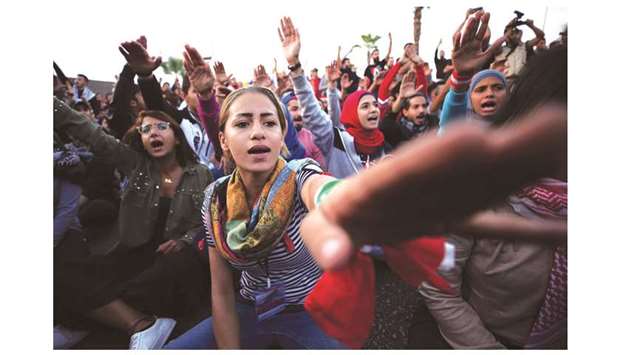 Demonstrators gesture as they block a road during ongoing anti-government protests in the port city of Sidon, Lebanon yesterday. The unrest is contributing to slower growth in the Middle East and North Africa (Mena) region, alongside global trade tensions, oil price volatility and a disorderly Brexit process, the IMF said in a report on the regional economic outlook.