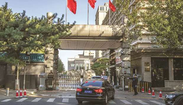 Chinese soldiers and security personnel secure the main entrance of Jingxi hotel in Beijing yesterday.