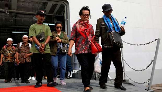 Relatives of passengers who died on Lion Air JT-610 that crashed into the Java sea, arrive at Jakarta International Port after attending one-year commemoration of the crash in Jakarta