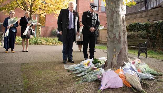 Britain's Prime Minister Boris Johnson stands with Chief Constable of Essex Police, Ben-Julian Harrington (R), after they laid flowers, during a visit to Thurrock Council Offices in Thurrock, east of London following the October 23, 2019, discovery of 39 bodies concealed in a lorry.
