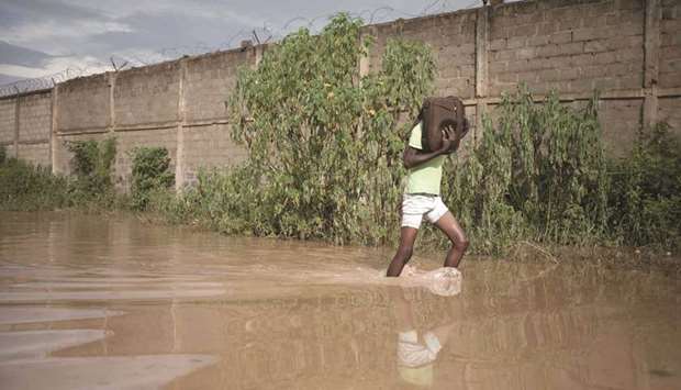 A student walks on a flooded street in Bangui yesterday.