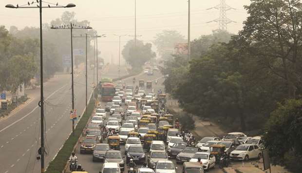 Vehicles drive through smog in New Delhi yesterday.