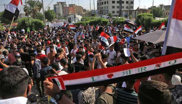Iraqis take part in ongoing anti-government protests in the central city of Karabala