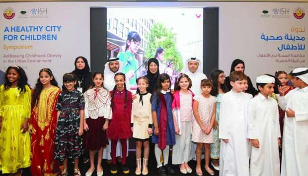 HE the Minister of Public Health Dr Hanan Mohamed al-Kuwari and HE the Minister of Education and Higher Education Dr Mohamed Abdul Wahed Ali al-Hammadi with other dignitaries and children at the symposium.