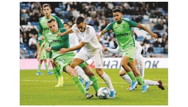 Real Madridu2019s Eden Hazard (centre) and Leganesu2019 Rodrigo Tarin vie for the ball during the La Liga match in Madrid. (Reuters)