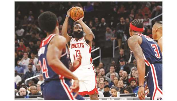 Houston Rockets guard James Harden (13) shoots the ball as Washington Wizards guard Bradley Beal (3) looks on in the first quarter of their NBA game on Wednesday.  PICTURE: Geoff Burke-USA TODAY Sports