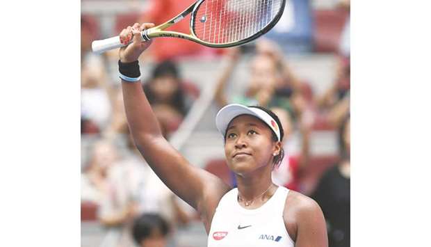 Naomi Osaka of Japan waves to the crowd after winning her third round match against Alison Riske of the US at the China Open in Beijing yesterday. (AFP)