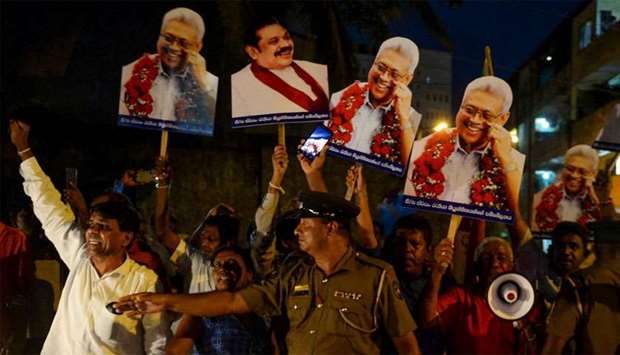 Supporters of former secretary to the ministry of defence and presidential candidate, Gotabaya Rajapaksa, celebrate outside Sri Lanka's Court of Appeal in Colombo