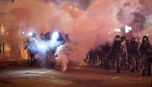 Riot police fire tear gas at protesters at Causeway Bay area in Hong Kong as people hit the streets after the government announced a ban on facemasks.