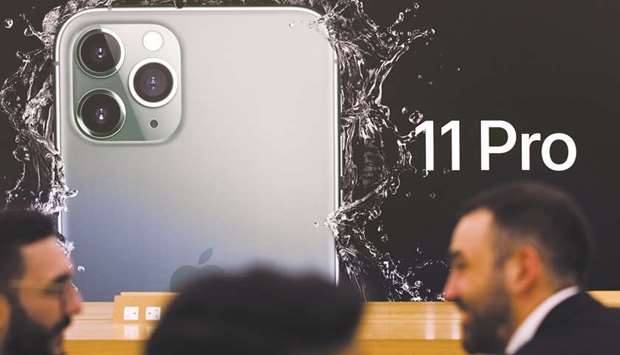 An advert for the iPhone 11 Pro smartphone is displayed inside the Regent Street Apple store during a product launch event in London on September 20. The iPhone 11 Prou2019s triple-camera system can switch smoothly between lenses when zooming in and out, keeping exposure and image quality consistent.
