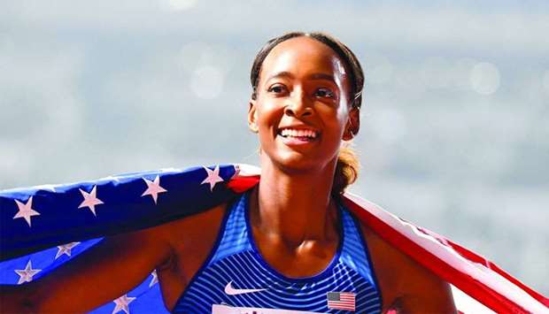USA's Dalilah Muhammad celebrates with the national flag after winning the Women's 400m Hurdles final at the 2019 IAAF Athletics World Championships at the Khalifa International Stadium in Doha