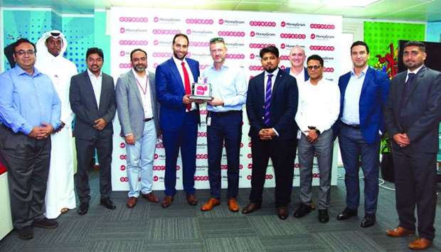 Ooredoo senior officials receiving the award during a recently-held ceremony