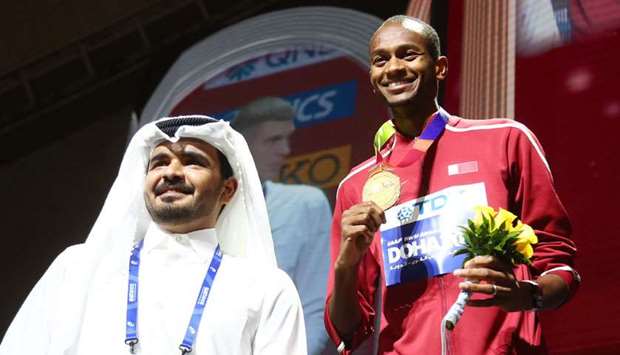 Qatar Olympic Committee president HE Sheikh Joaan bin Hamad al-Thani crowns world high jump champion Mutaz Barshim with gold medal.