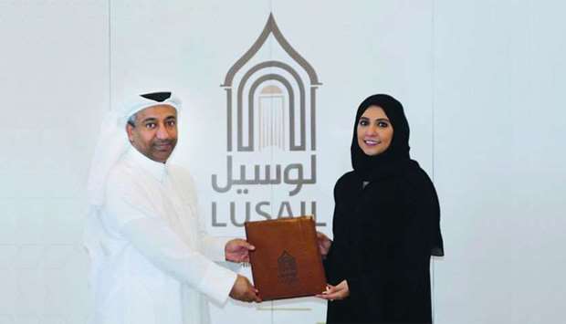 Maryam al-Mansoori with Khaled Mubarak al-Dulaimi at the signing ceremony.rnrn