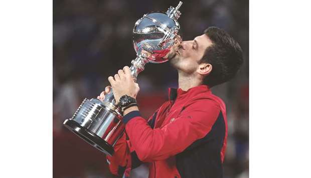 Novak Djokovic celebrates with the trophy after winning the final against John Millman at the Japan Open in Tokyo, yesterday. (AFP)