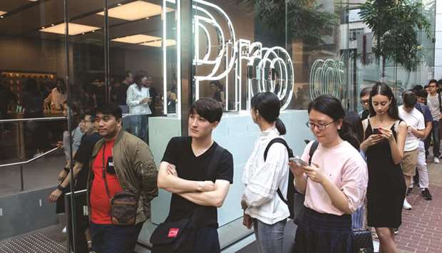 Customers wait in line outside an Apple store during the launch of the iPhone 11 and Apple Watch Series 5 devices in Hong Kong on September 20.