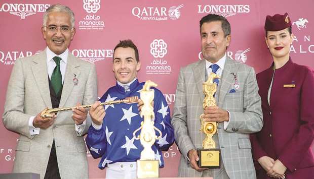His Highness Sheikh Abdullah bin Khalifa al-Thani, jockey Maxime Guyon and His Highness Sheikh Mohamed bin Khalifa al-Thani pose during the awards ceremony after Ebrazu2019s victory in the Qatar Arabian World Cup (Gr1 PA) at ParisLongchamp yesterday afternoon.