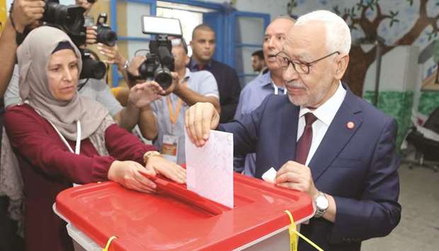 Ennahda Party leader Rached Ghannouchi casts his ballot at a polling station in the capital Tunis, yesterday, during the third round of legislative elections.
