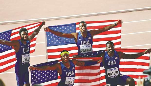 (From L to R) USAu2019s Noah Lyles, Michael Rodgers, Christian Coleman and Justin Gatlin pose with their national flag after winning the Menu2019s 4x100m Relay final at the 2019 IAAF World Athletics Championships at the Khalifa International Stadium in Doha on October 5.