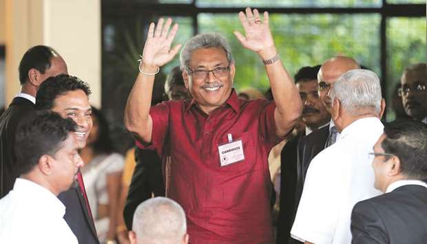 Sri Lanka Peopleu2019s Front party presidential election candidate and former wartime defence chief Gotabhaya Rajapakse waves at media as he arrives to hand over nominations papers at the election commission ahead of Sri Lankau2019s presidential election, in Colombo, Sri Lanka.
