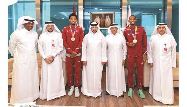 L to R: Former Asian sprint champion Talal Mansour; CEO, Ooredoo Qatar, Waleed al-Sayed, hurdler Abderrahman Samba, Second Vice-President of the Qatar Olympic Committee and President of Qatar Athletics Federation (QAF) Dr Thani bin Abdulrahman al-Kuwari, Ooredoo Chairman HE Sheikh Abdulla bin Mohamed al-Thani, world champion high jumper Mutaz Barshim and Ooredoo Group CEO Sheikh Saud bin Nasser al-Thani pose during the felicitation ceremony. At bottom, Ooredoo Chairman HE Sheikh Abdulla with Barshim and Samba.