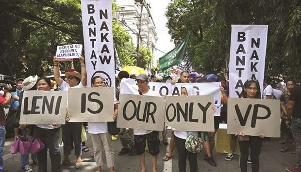 Supporters of Vice President Leni Robredo carry placards as they hold a rally in front of the Supreme Court in Manila, yesterday, as the high court hears an electoral challenge from Bongbong Marcos, the son of the former dictator Ferdinand Marcos.