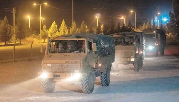 Turkish army soldiers drive towards the border with Syria near Akcakale in Sanliurfa province, yesterday.