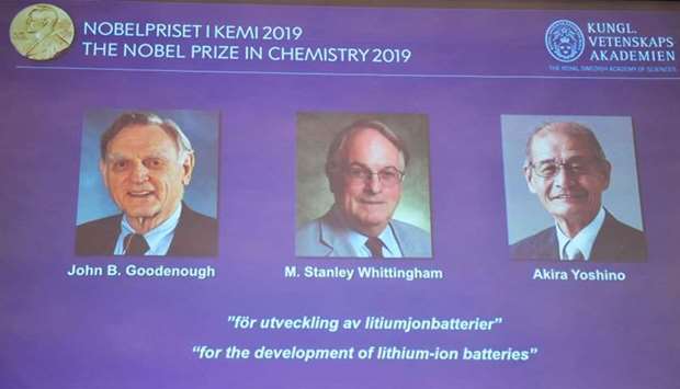 A screen displays the portraits of the laureates of the 2019 Nobel Prize in Chemistry (L-R) John B. Goodenough, M. Stanley Whittingham, and Akira Yoshino ,for the development of lithium-ion batteries, during a news conference at the Royal Swedish Academy of Sciences in Stockholm