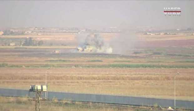 Smoke rises from an explosion in the border town of Tel Abyad, Syria, as seen from Akcakale, Turkey