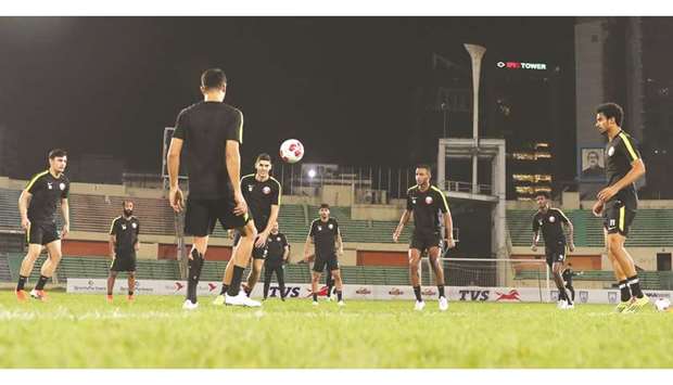 Members of the Qatar team train under the watchful eyes of coach Felix Sanchez (R).