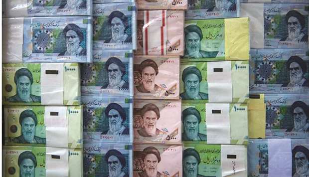 Iranian rial banknotes stand on display at a currency exchange in Tehran (file). The currency has lost about 56% of its value in 2020.