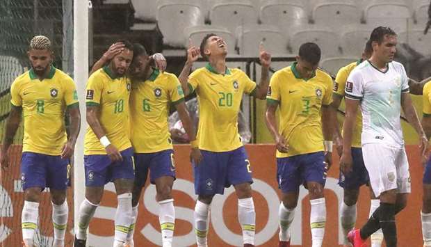 Brazilu2019s Roberto Firmino (fourth from left)) celebrates with teammates after scoring against Bolivia during their 2022 FIFA World Cup South American qualifier at the Neo Quimica Arena in Sao Paulo, Brazil. (AFP)