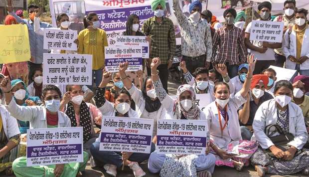 Paramedical volunteers, previously hired to help with the Covid-19 pandemic, shout slogans as they protest against the Punjab government for discontinuing their services, in Amritsar yesterday.
