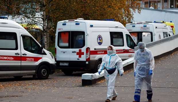 Medical specialists walk next to ambulances near the Aleksandrovskaya hospital, amid the outbreak of the coronavirus disease in Saint Petersburg, Russia, on October 9.