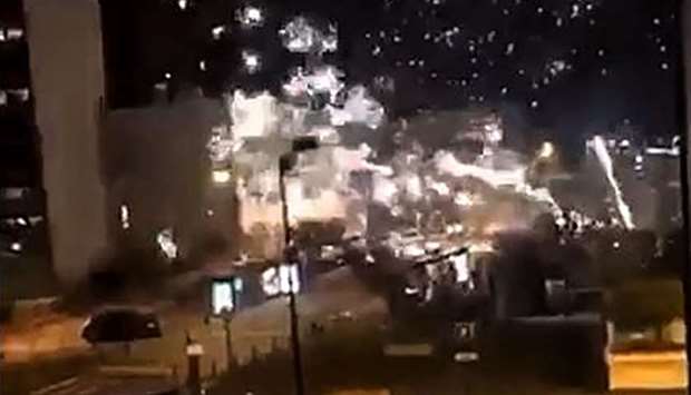 An image grab made from a video posted on the Twitter account of @LeCapricieux94 that shows fireworks exploding outside the police station of Champigny-sur-Marne, outside Paris, in the night of October 10 to 11, as it is attacked by around 40 people launching fireworks.  AFP / Twitter account of @LeCapricieux94