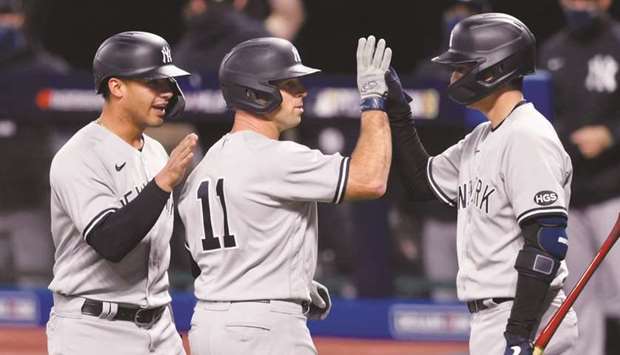 New York Yankees left fielder Brett Gardner (centre) celebrates with shortstop Gleyber Torres (left) and catcher Kyle Higashioka after hitting a two-run home run against the Cleveland Indians in the seventh inning at Progressive Field in Cleveland. (USA TODAY Sports)