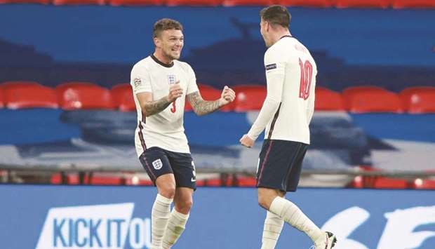 Englandu2019s midfielder Mason Mount (right) celebrates with teammate Kieran Trippier after scoring against Belgium in the UEFA Nations League match at the Wembley Stadium in London yesterday. (AFP)