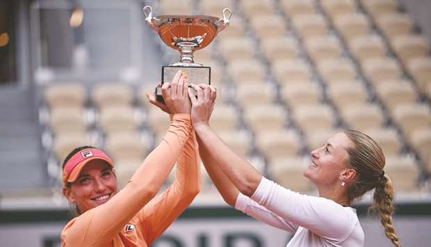 Hungaryu2019s Timea Babos (left) and Franceu2019s Kristina Mladenovic pose with the Simone Mathieu Cup after winning the French Open womenu2019s doubles title at Roland Garros in Paris, France yesterday. (AFP)