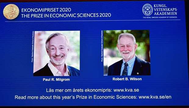 Pictures of the winners of the 2020 Nobel prize in economic sciences, Paul R. Milgrom and Robert B. Wilson, are displayed on a screen at a news conference in Stockholm, Sweden.