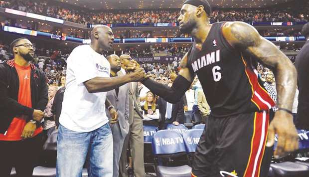 In this April 28, 2014, picture, Michael Jordan (second from left), owner of the team that was then called Charlotte Bobcats, shakes hands with the then Miami Heat forward LeBron James after Game 4 of the NBA Eastern Conference quarter-finals in Charlotte, United States. (TNS)