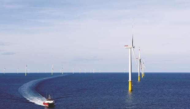 A boat sails past DanTysk wind farm, 90km west of Esbjerg, Denmark (file). Fifty-five firms have committed to a framework released on Thursday for setting climate goals specific to mortgages, bonds and other asset classes in their portfolios, said the Science Based Targets initiative, a consortium that developed the framework.