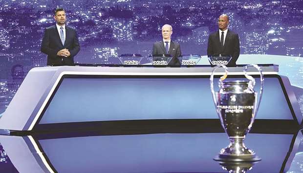 Didier Drogba and UEFA General Secretary and Director of Football Giorgio Marchetti during the Champions League draw in Geneva yesterday.