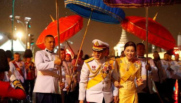 Thailand's King Maha Vajiralongkorn and Queen Suthida greet royalist supporters who gathered outside the Grand Palace to mark the 4th year anniversary of late King Bhumibol Adulyadej's death, in Bangkok, Thailand