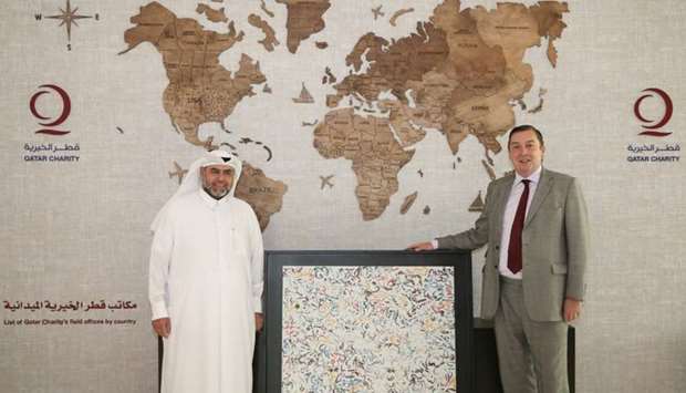 Qatar Charity CEO Yousuf al-Kuwari and British ambassador Jonathan Wilks.