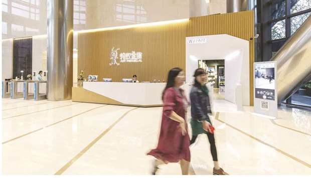 Employees walk through the Ant Financial headquarters in Hangzhou. Chinau2019s securities regulator is probing a potential conflict of interest in Ant Groupu2019s planned $35bn stock listing, delaying approval for what could be the worldu2019s largest IPO.